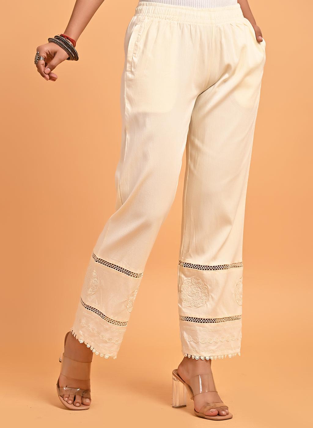 White cotton pants with embroidered detailing at hem by Free
