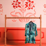 Front view of a hanging Kinza Blue Crepe Printed Long Top