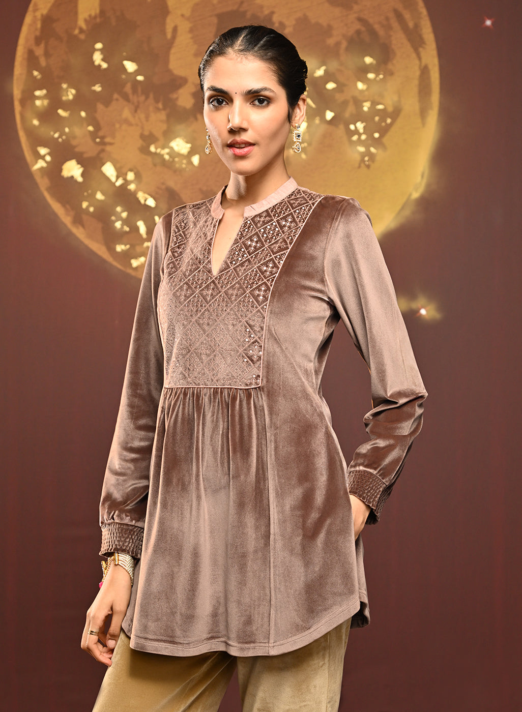 Woman showing move in Qainaat Beige Embroidered Velvet Top