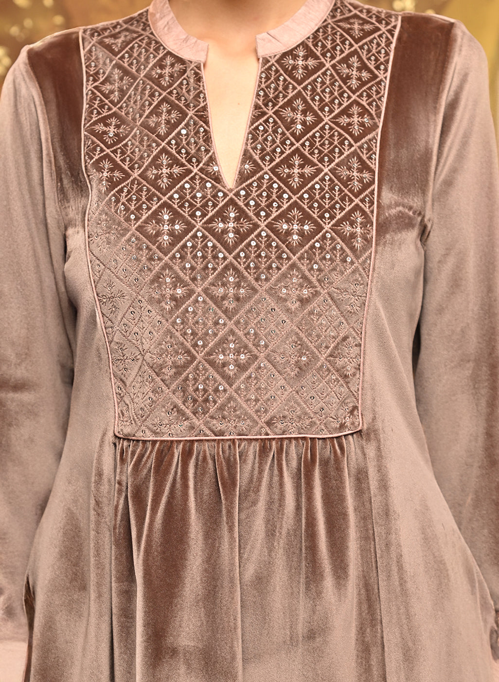 The intricate neckline work of Qainaat Beige Embroidered Velvet Top for Women