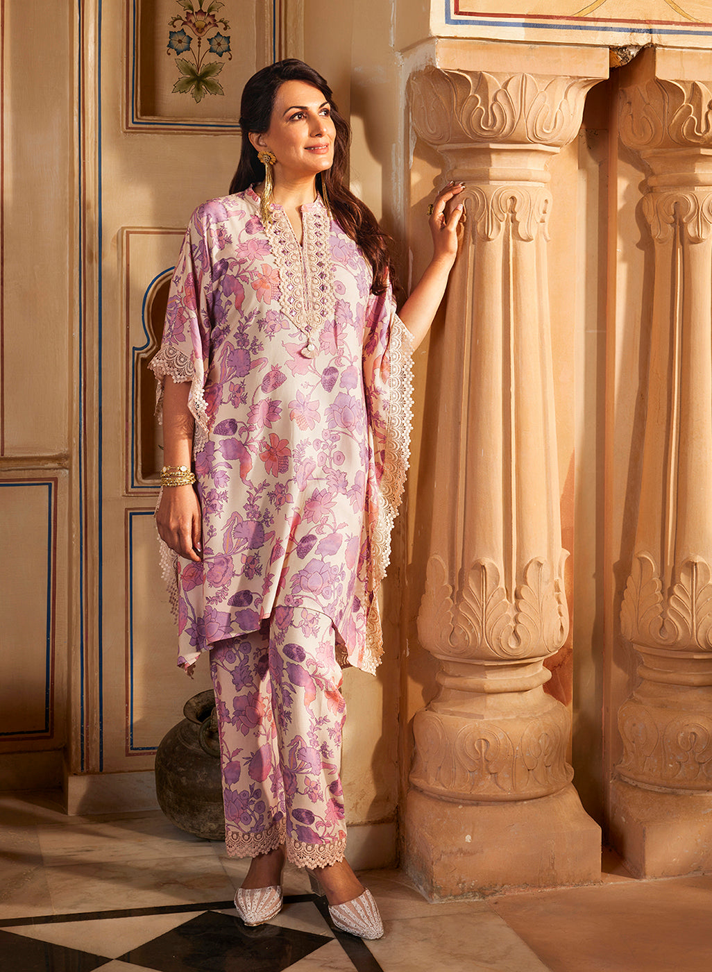 A middle-aged elegant woman wearing Mahin Mauve Printed Kaftan Kurta Set on a royal set