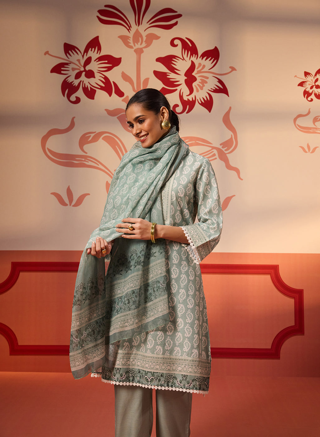 A woman wearing a Fiona Aqua Printed Cotton Linen Set with draping the Dupatta