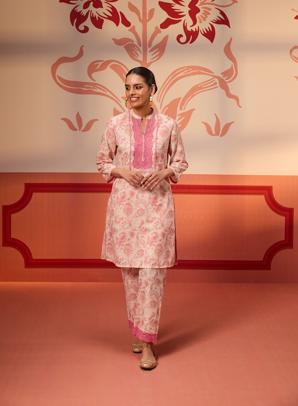 Roshna Coral Printed Cotton Linen Kurta Set hanging with a floral backdrop