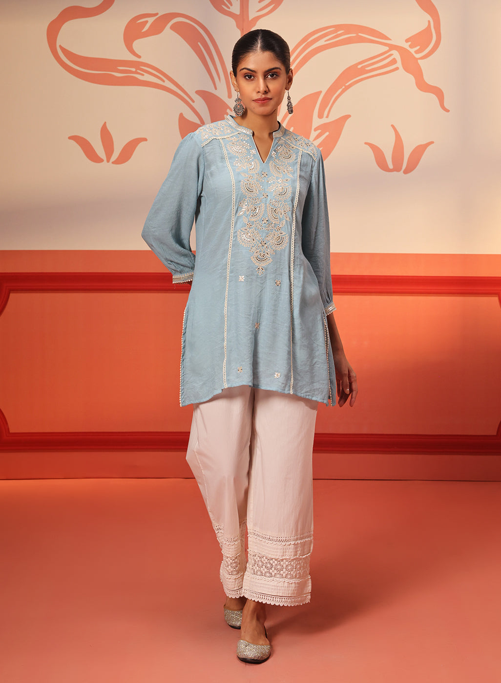 Woman flaunting Kashaf Crimson Blue Embroidered Crinkled Crepe Long Top pairing with white palazzos