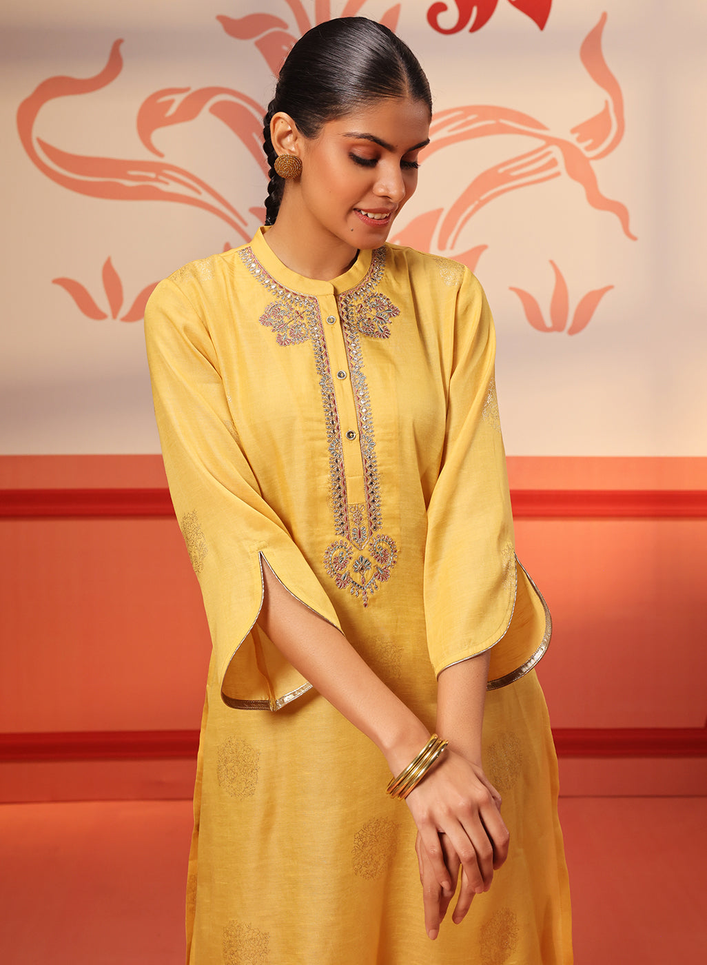 Woman showing the sleeves of her Rumi Bright Yellow Printed Tunic