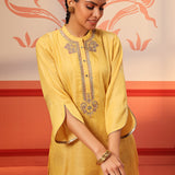 Woman showing the sleeves of her Rumi Bright Yellow Printed Tunic