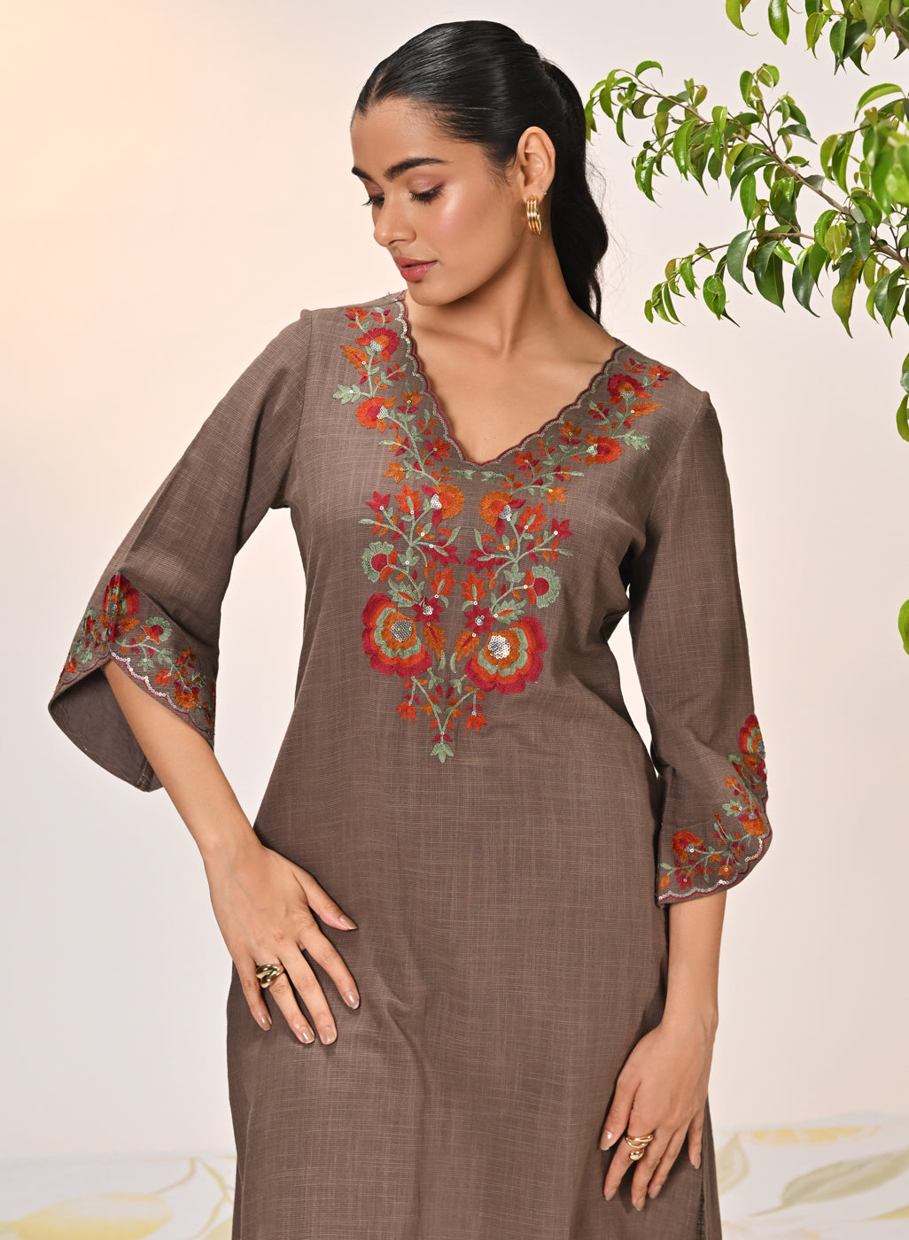 Kamali Umber Embroidered Cotton Linen Slub Designer Kurta Set paired with golden jewelry