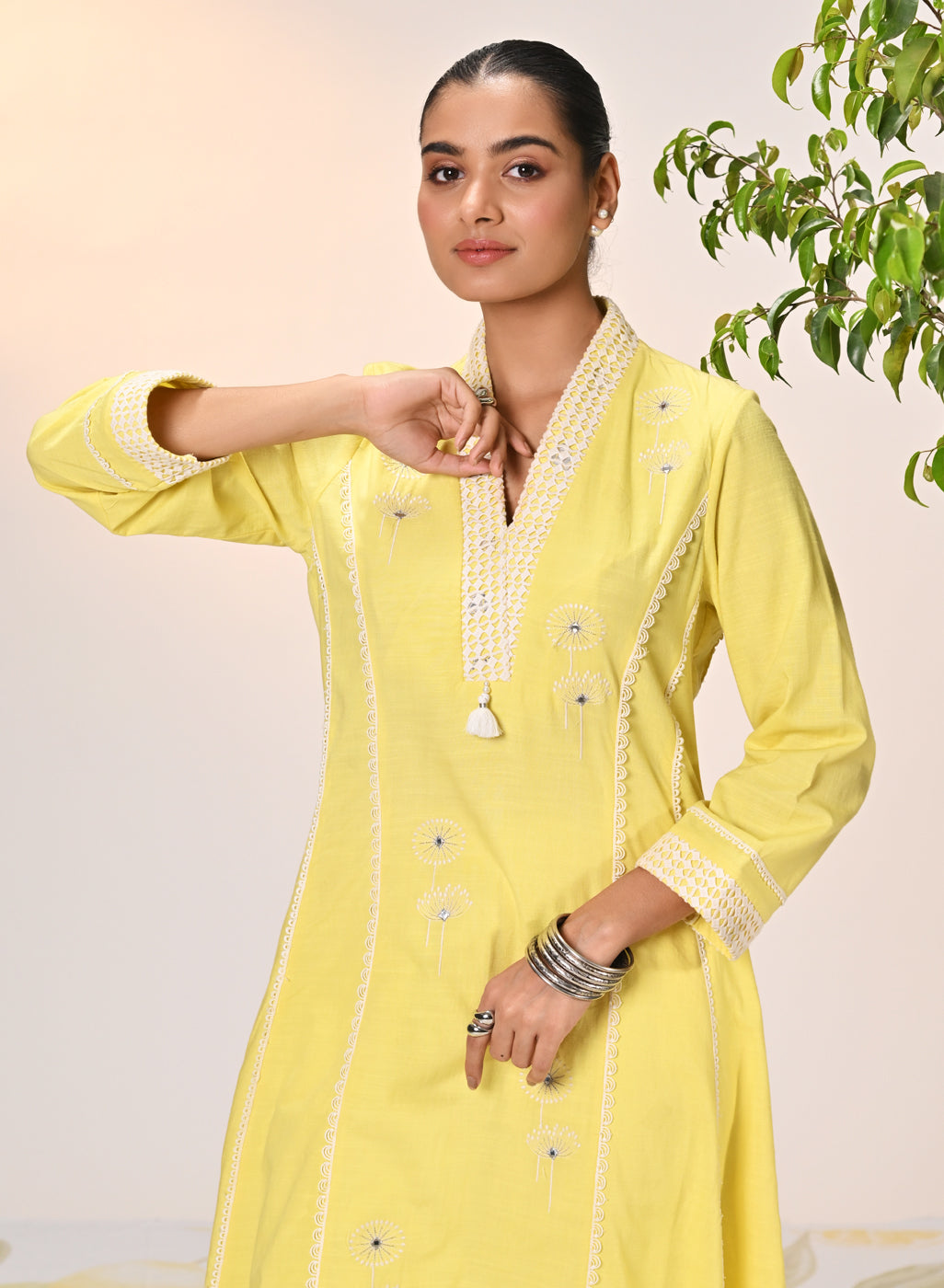 A young woman posing in Zainab Lemon Embroidered Cotton Linen Indo-western Dress