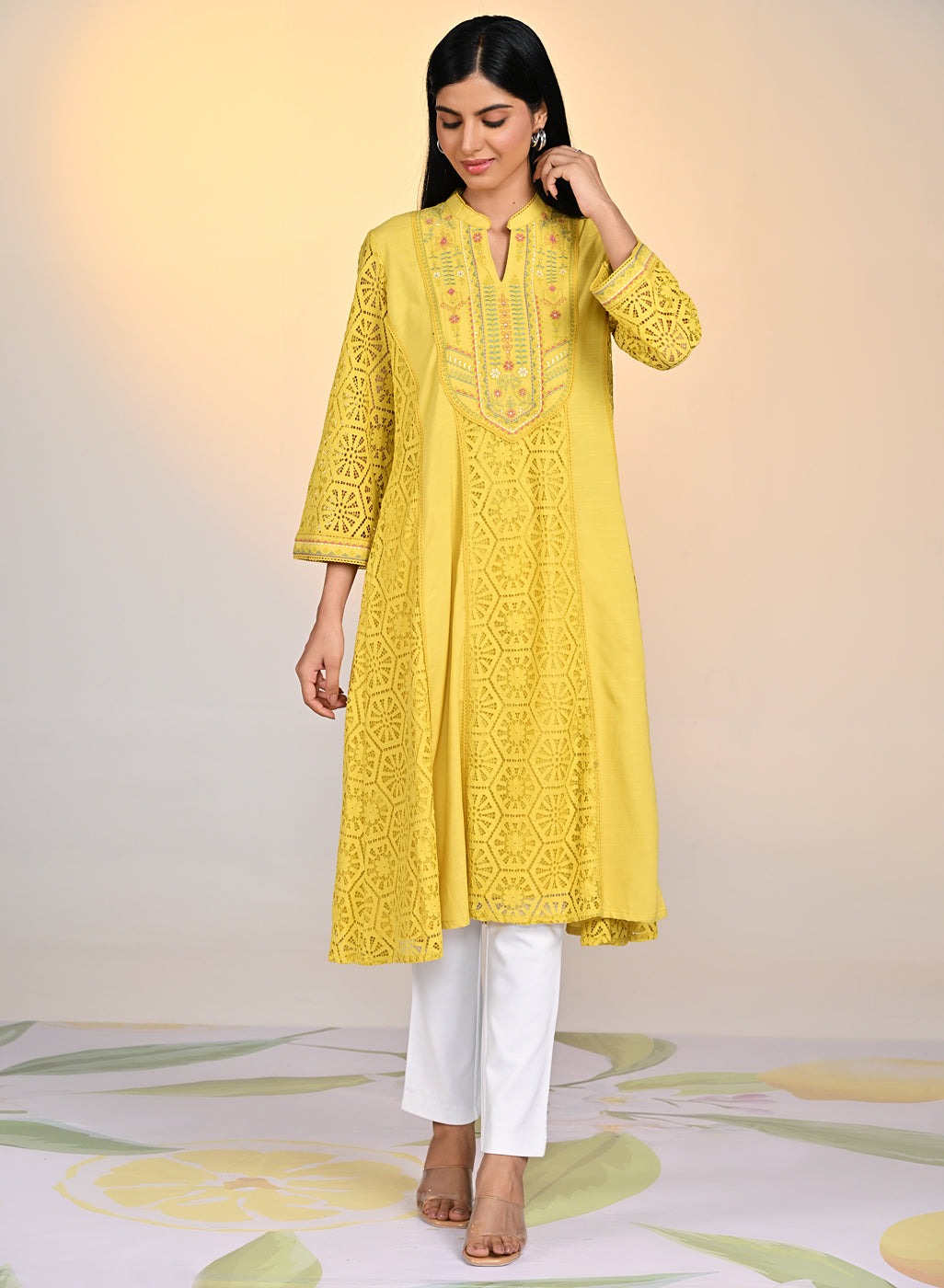 Woman wearing Fariha Carnation Yellow Embroidered Raschel Net Dress with white pants