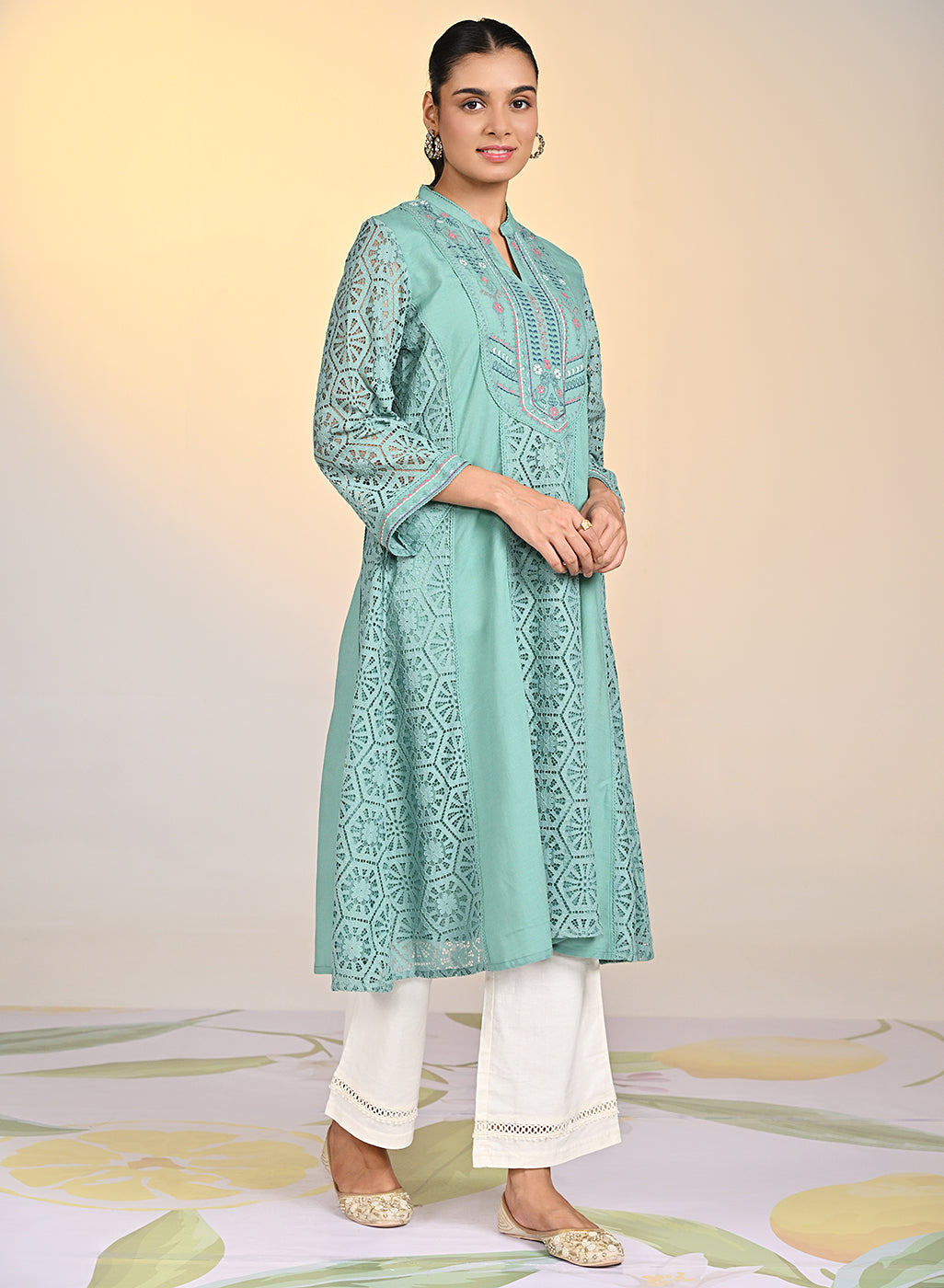 Woman in Fariha Carnation Green Embroidered Raschel Net Dress and white palazzos