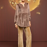 Woman in Qainaat Beige Embroidered Velvet Top paired with bottoms