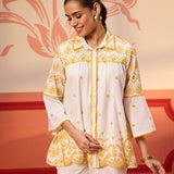 Woman smiling in Masakali Ivory with a Yellow Embroidered Schiffli Shirt