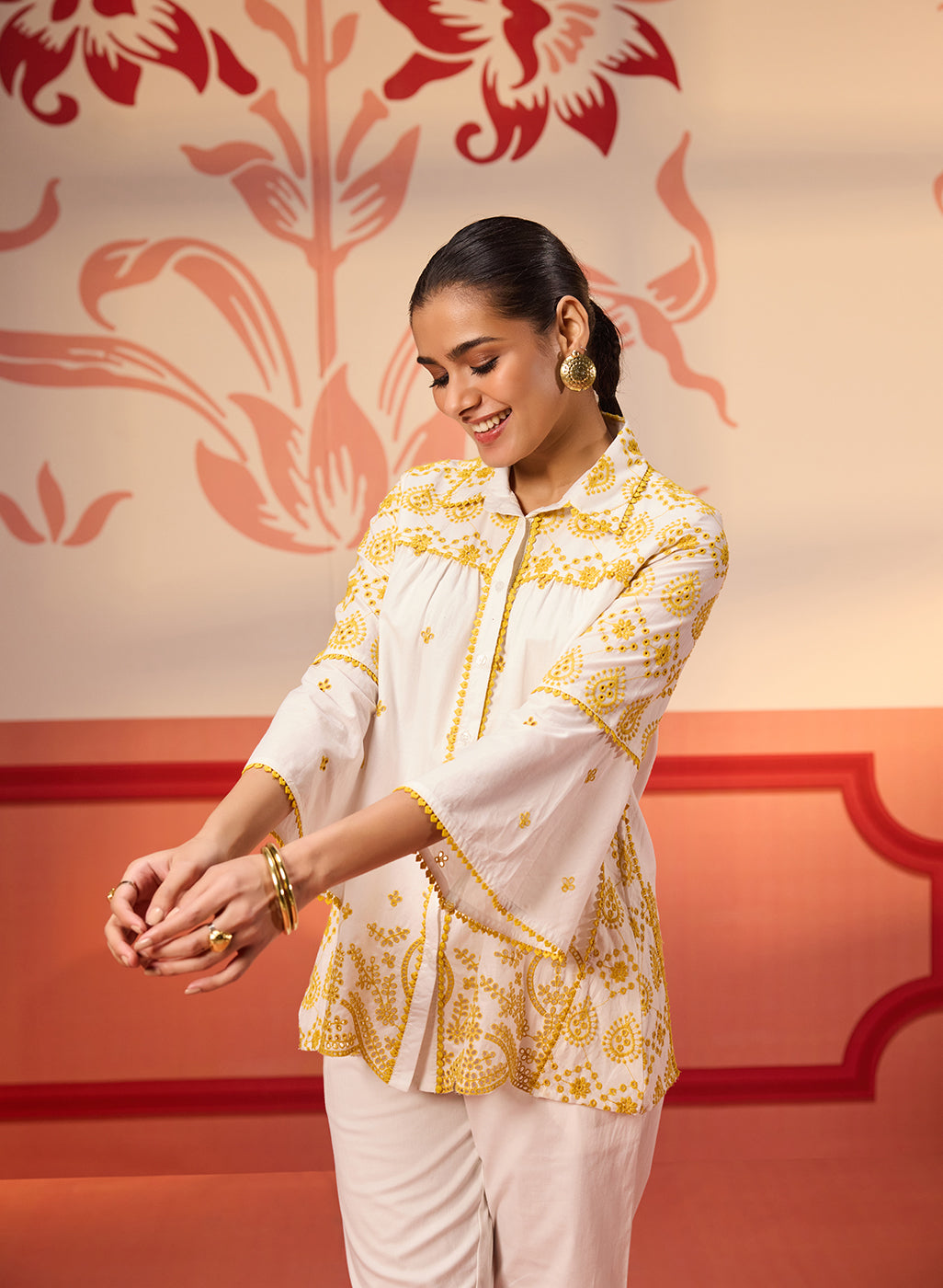 Woman showing the sleeves of Masakali Ivory with a Yellow Embroidered Schiffli Shirt