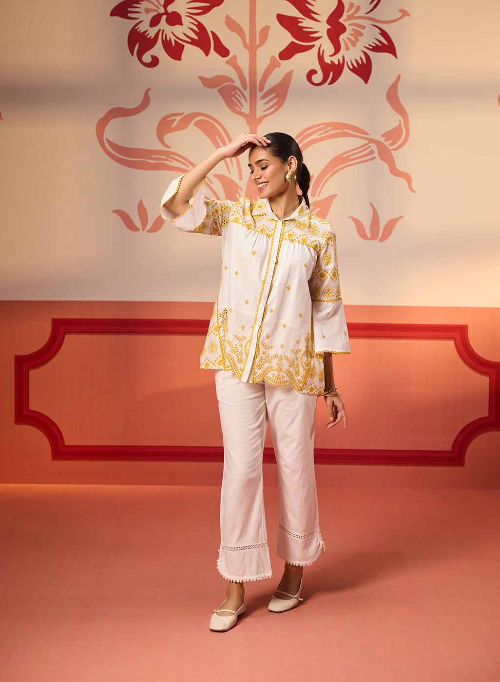 Front view of a woman wearing Masakali Ivory with a Yellow Embroidered Schiffli Shirt paired with white bottoms