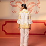 Back view of a woman wearing Masakali Ivory with a Yellow Embroidered Schiffli Shirt paired with white bottoms