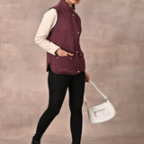 Maroon Solid Sleeveless Quilted Jacket With Rivets Detail & Curved Hem - Lakshita