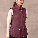 Maroon Solid Sleeveless Quilted Jacket With Rivets Detail & Curved Hem - Lakshita