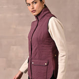 Maroon Solid Sleeveless Quilted Jacket With Rivets Detail & Curved Hem - Lakshita